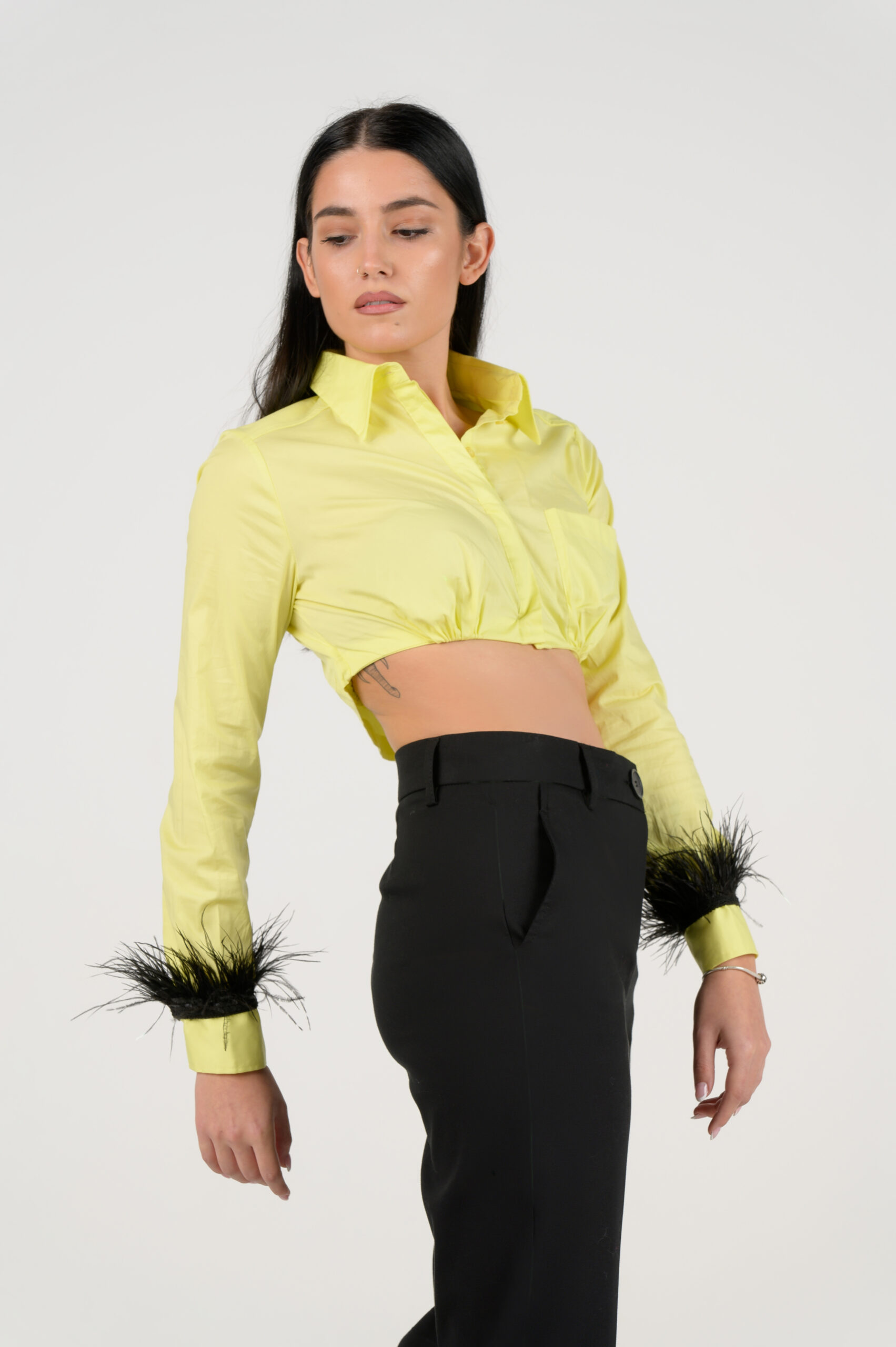 Cropped yellow shirt with feathers on the sleeves