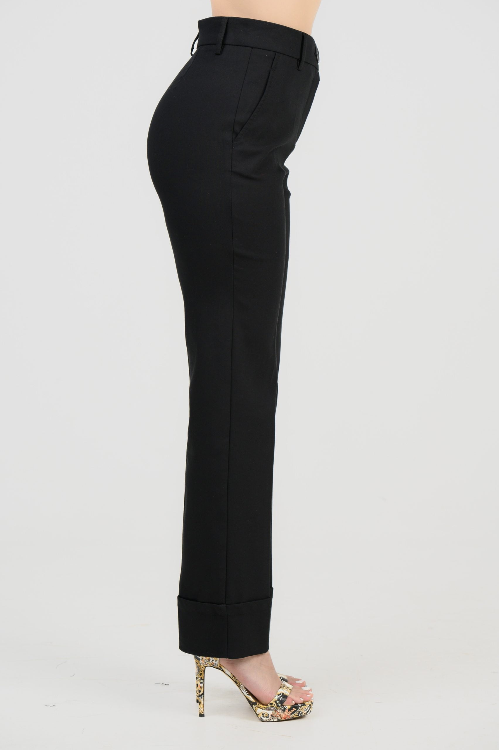 Black trousers in straight line, from the side.