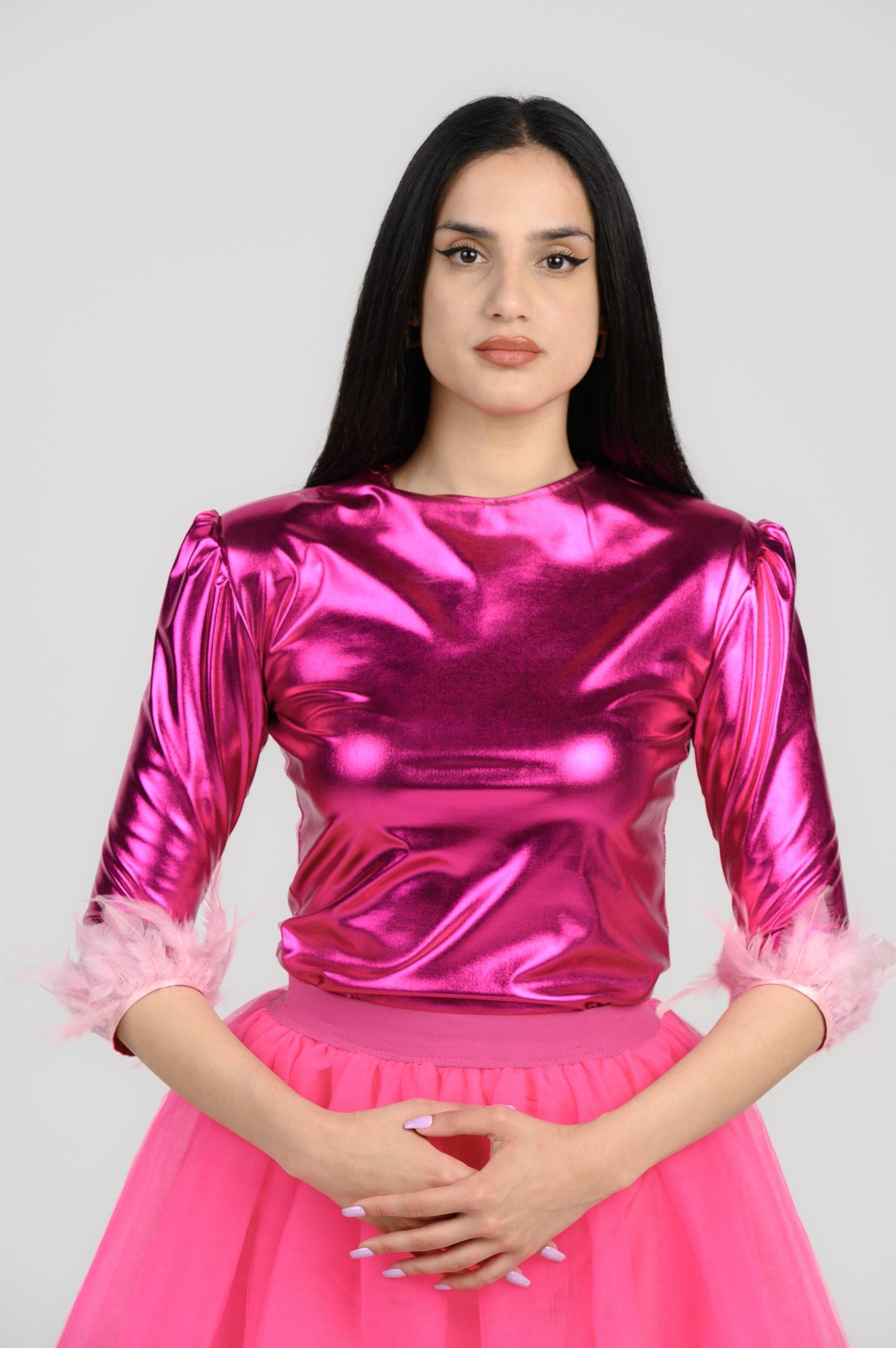 Fuchsia foil bodysuit, with 3/4 sleeves and light pink feathers on them.