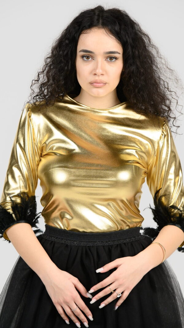 Gold foil bodysuit, with 3/4 sleeves and black feathers on them.