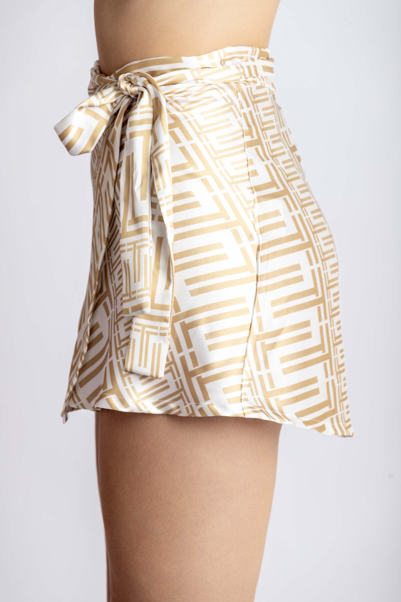 Mini wrap-around skirt, with triamia print on, side.