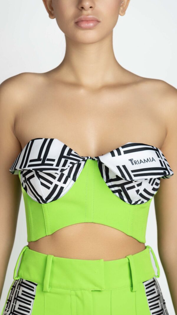 Corset top in neon green and black and white triamia pattern. Cross-ties on the back with triamia ribbon.