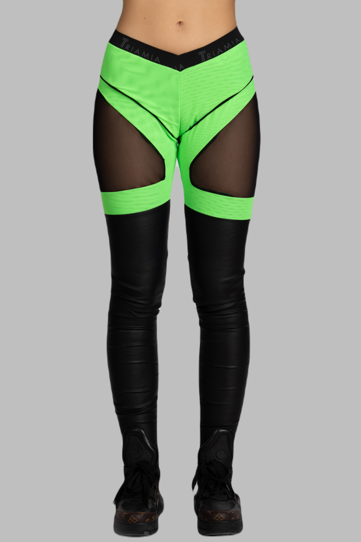 Leggings with combination of fabrics in black and neon green. Front.