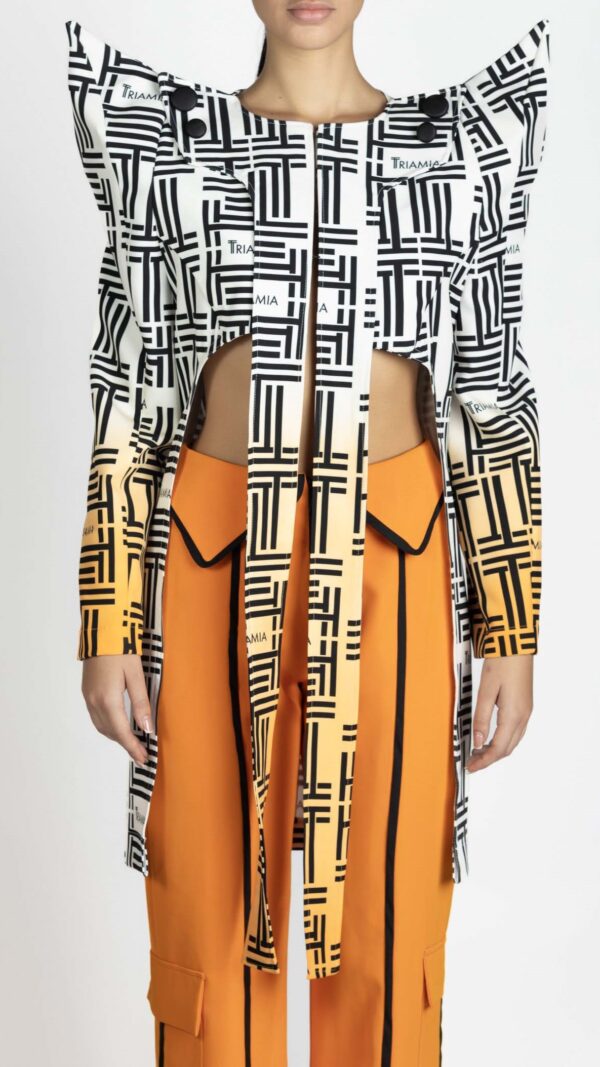 Blazer that's long on the back and cropped on the front, with triamia print all over, orange ombre details on the sleeves and pointed shoulders. Front photo.