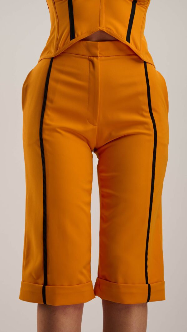 Bermuda Pants in orange with black line detail and pockets